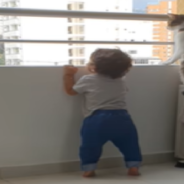 Cat Protects Toddler And Keeps Him Away From The Balcony Ledge