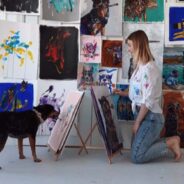 An Artist Bonds with Her Dog with Paint Brushes and Splashes of Color